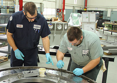 Apprentices work on the shop floor.